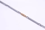 Stainless Steel Thin Link Bracelet With Center Rose Gold Link Of Greek Key Design
